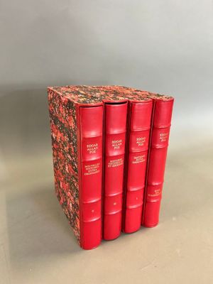 four red books stacked on top of each other on a table
