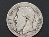 a close up of a silver coin with a man ' s face on it