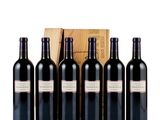 six bottles of red wine in front of a wooden box