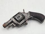 an old gun with a wooden handle on a white surface