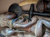 many different types of african art displayed on the wall