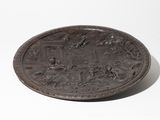 an antique bronze plate with a scene of a man and a woman in a garden