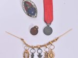 a necklace with a medal, a medal, and a medal on it