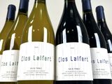 several bottles of wine are lined up on a table