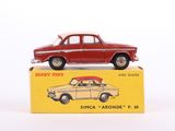 an old red toy car sitting on top of a yellow box
