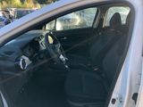 the interior of a car with the door open and the driver ' s seat down