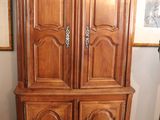 a large wooden cabinet in the corner of a room