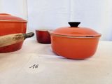 two pots and a pan on a table