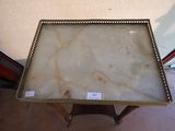 an antique marble table with a gold frame and a label on it