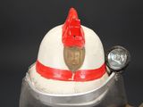 a fireman ' s helmet with a red ribbon on it