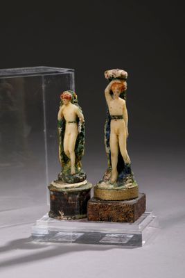 two figurines that are on display in a glass case