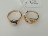 two gold rings with diamonds and a price tag