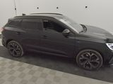 the black suv is parked in the garage on the checkered floor