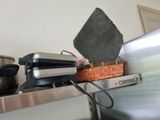 a toaster and a toaster sitting on a shelf in a kitchen