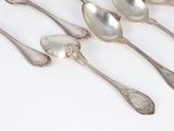 five spoons that are sitting next to each other on a table