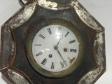 a small clock with roman numerals on the face