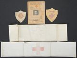 several pieces of paper with a red cross on them on a black surface