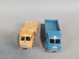 two toy trucks sitting next to each other on a table
