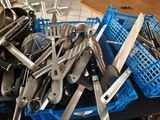 pile of kitchen utensils in a blue crate on a kitchen counter