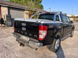a black pick up truck that is parked in a lot