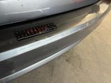 a sticker on the bumper of a silver car