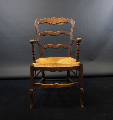 a wooden chair with a wooden seat on a black background