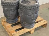 three pots with faces on them sitting on a pallet