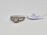 a close up of a ring on a white surface with a tag