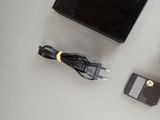a black box and a charger on a table