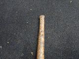 a baseball bat that is laying on the ground