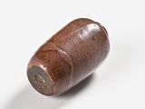 a small wooden object that is on a white surface