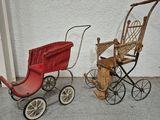 two antique baby strollers next to each other on the sidewalk