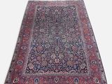 un tapis persan ancien aux couleurs bleu et rouge