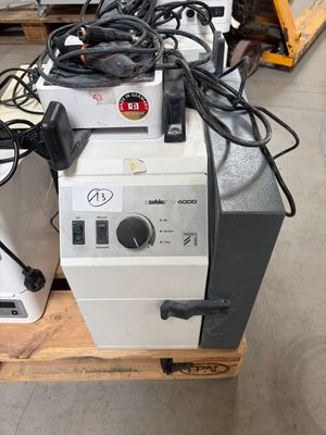a pile of electrical equipment sitting on a pallet in a warehouse