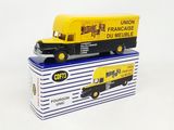 yellow and black toy truck sitting on top of a blue and white box