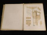 an open book with a drawing of a house on it