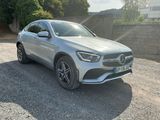 a silver mercedes suv parked in a gravel parking lot