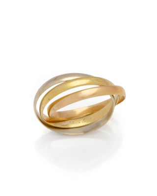 a close up of a gold ring on a white background