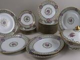 a lot of plates and bowls that are sitting on a table