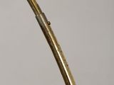 brass plated table lamp with a curved metal base and a brass plated base