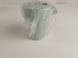 a plastic bag with a piece of cloth in it on a white surface