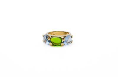 a close up of a ring with a green stone in it