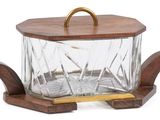 a glass container with a wooden handle on a stand