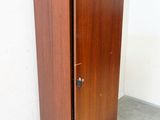 a tall wooden cabinet in a corner of a room