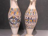 two vases that are sitting on a table