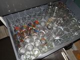 a drawer full of empty wine glasses on the floor