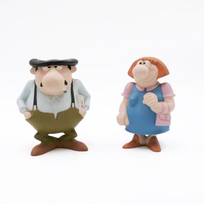 two figurines of a man and a woman standing next to each other