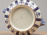 a blue and white plate with a fish design on it