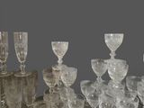 a lot of glasses and cups sitting on a table