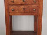 a wooden table with drawers and a shelf on top of it